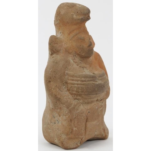 45 - A pre-Columbian terracotta figure, Guatemala, Mesoamerican region. Modelled  in ceremonial attire we... 