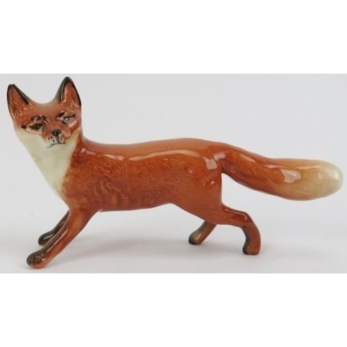 55 - A Beswick ceramic fox hunting set. Comprising a huntsman, ten hunting dogs, and a fox. (12 items) Ho... 