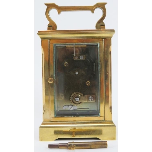 58 - An English brass carriage clock by Huber, late 19th/early 20th century. With bevelled glass, enamell... 