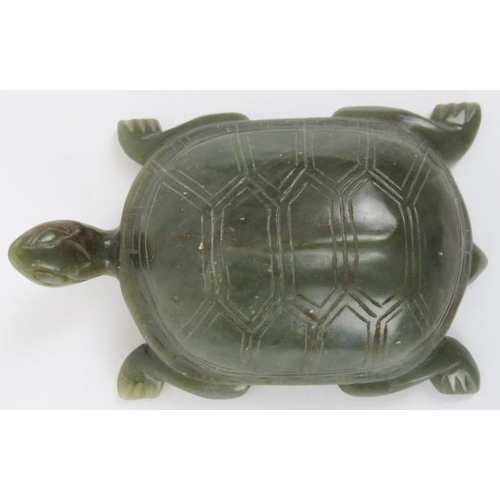 75 - A Chinese green and russet jade carving of a tortoise, 20th century. Carved with incised features th... 