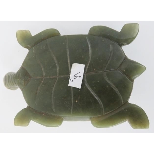 75 - A Chinese green and russet jade carving of a tortoise, 20th century. Carved with incised features th... 