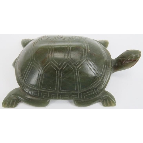 75 - A Chinese green and russet jade carving of a tortoise, 20th century. Carved with incised features th... 