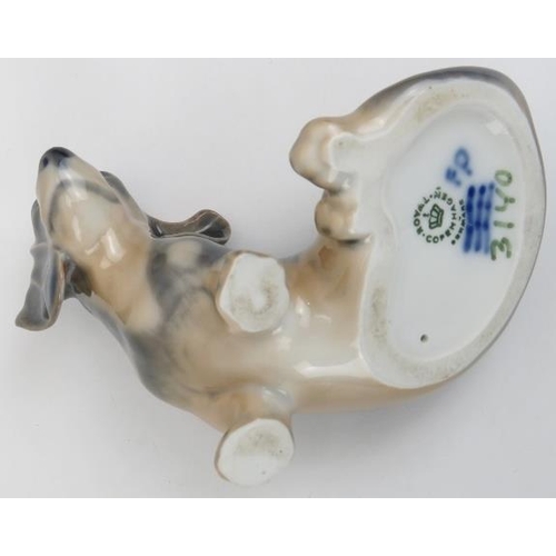 88 - Two Royal Copenhagen porcelain dogs. Comprising a West Highland Terrier and a Dachshund. Both marked... 