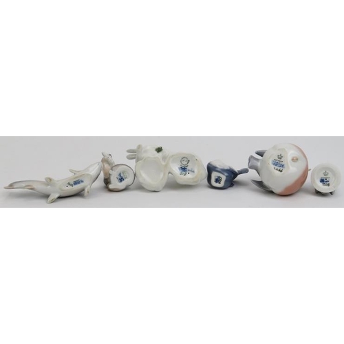 89 - A group of six Royal Copenhagen porcelain animal figurines. Comprising two white rabbits, an otter w... 