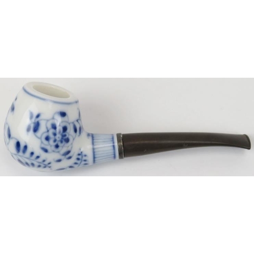 90 - A Royal Copenhagen blue and white porcelain pipe and stand. With a florally decorated bowl and stand... 