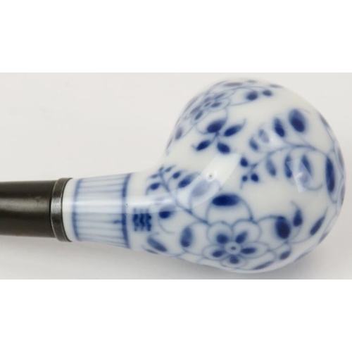 90 - A Royal Copenhagen blue and white porcelain pipe and stand. With a florally decorated bowl and stand... 