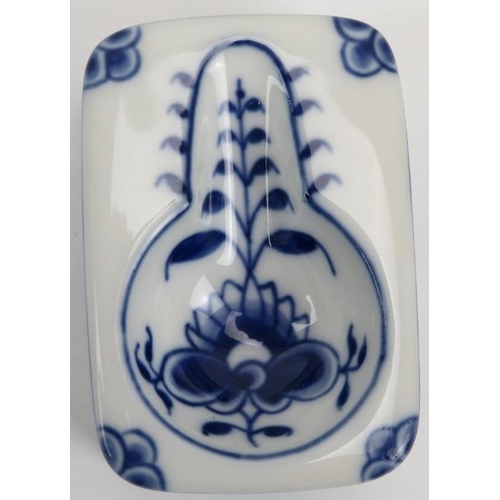 90 - A Royal Copenhagen blue and white porcelain pipe and stand. With a florally decorated bowl and stand... 