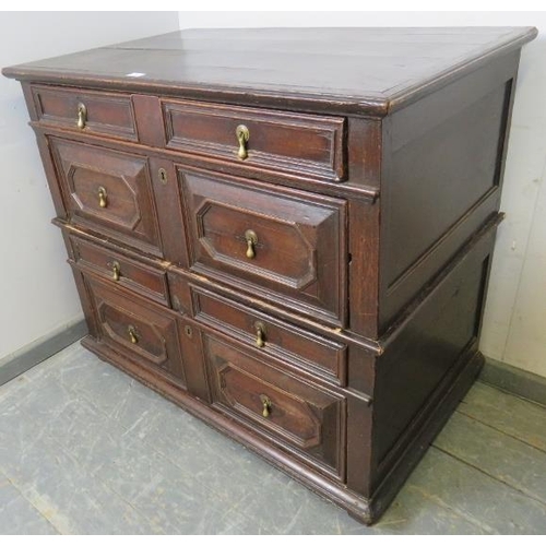 701 - A 17th century oak chest of four long graduated drawers, with geometric moulding and brass drop hand... 