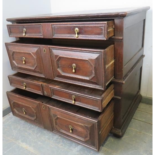 701 - A 17th century oak chest of four long graduated drawers, with geometric moulding and brass drop hand... 