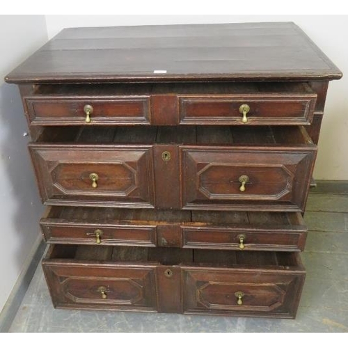 701 - A 17th century oak chest of four long graduated drawers, with geometric moulding and brass drop hand... 