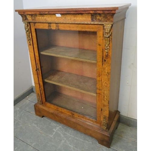 705 - A 19th century walnut pier cabinet with marquetry inlay and gilt metal mounts, the glazed door openi... 