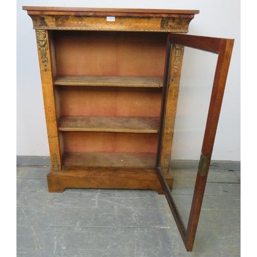 705 - A 19th century walnut pier cabinet with marquetry inlay and gilt metal mounts, the glazed door openi... 