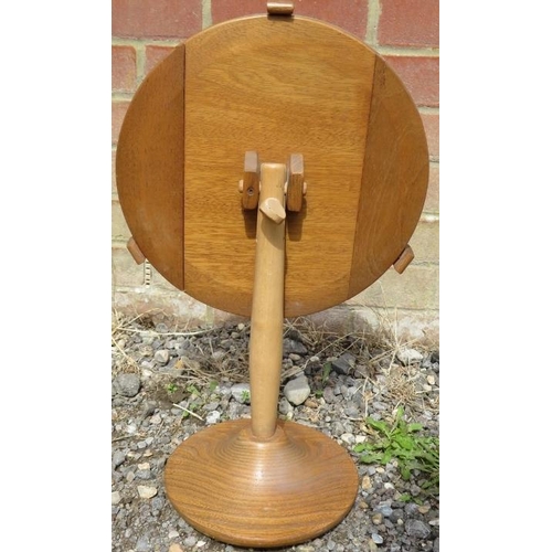 710 - A rare elm and beech Windsor tabletop adjustable vanity mirror by Ercol, on a turned plinth base. Pu... 