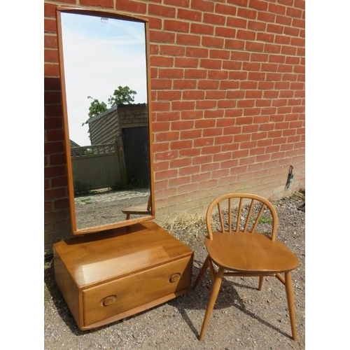 712 - A mid-century blonde elm Windsor cheval mirror by Ercol, on a box base housing one long drawer, rais... 