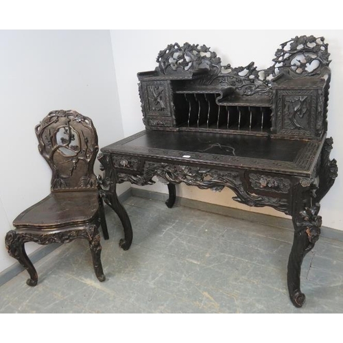 717 - A vintage ebonised writing desk in the 19th century Chinese style, the upper gallery with fitted cup... 