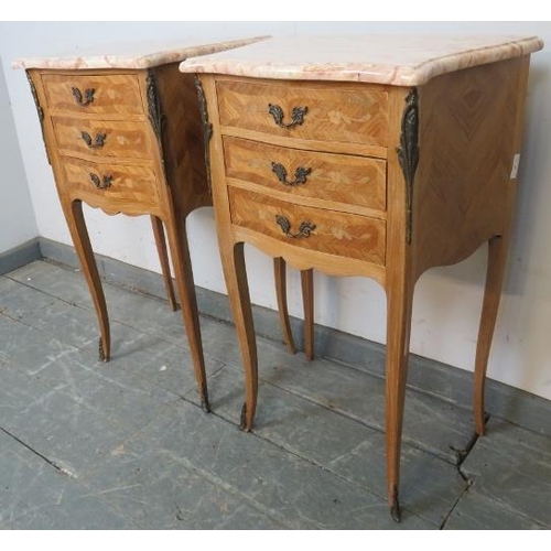 718 - A pair of vintage French tulipwood ormolu mounted bedside cabinets, with white marble tops, each hou... 