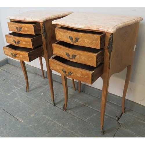 718 - A pair of vintage French tulipwood ormolu mounted bedside cabinets, with white marble tops, each hou... 