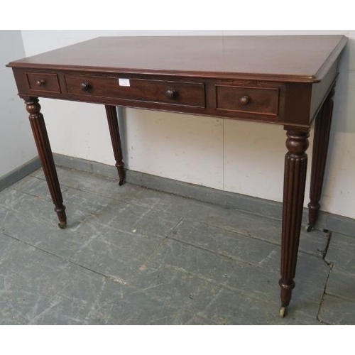 721 - A 19th century mahogany writing table in the manner of Gillows, housing one long cock-beaded drawer ... 