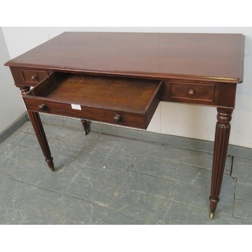 721 - A 19th century mahogany writing table in the manner of Gillows, housing one long cock-beaded drawer ... 