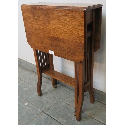 723 - An Edwardian medium oak Sutherland table, on square supports with small brass castors. 
H69cm W46cm ... 