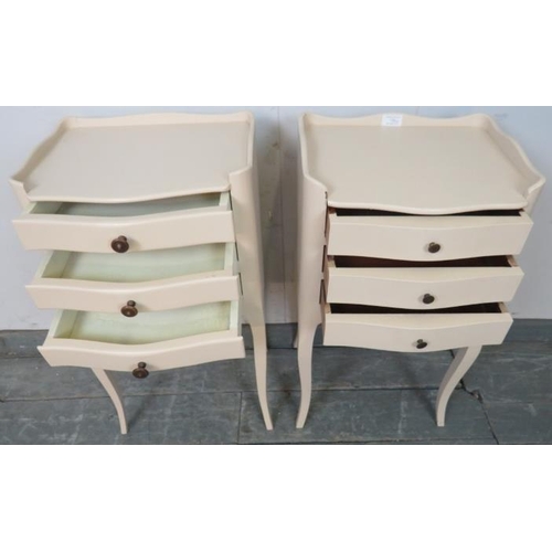 726 - A near pair of vintage French bedside cabinets painted cream, each with ¾ gallery and housing three ... 