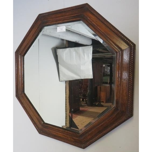 728 - An early 20th century octagonal bevelled wall mirror in an oak surround with braided rope edge detai... 