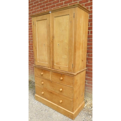 730 - An antique pine linen press, the doors opening onto twin hanging rails, the base section with two sh... 