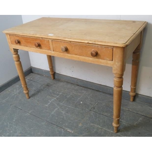 733 - An antique stripped pine side table, housing two short drawers with turned wooden handles, on taperi... 