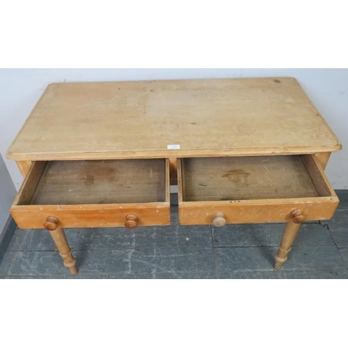 733 - An antique stripped pine side table, housing two short drawers with turned wooden handles, on taperi... 