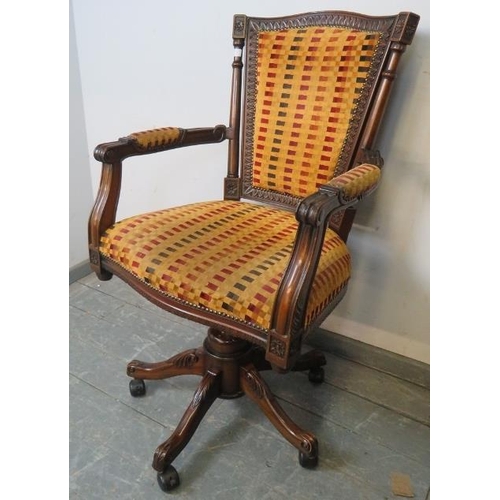 737 - An Edwardian style mahogany captain’s swivel and height adjust desk chair with carved frame and scro... 