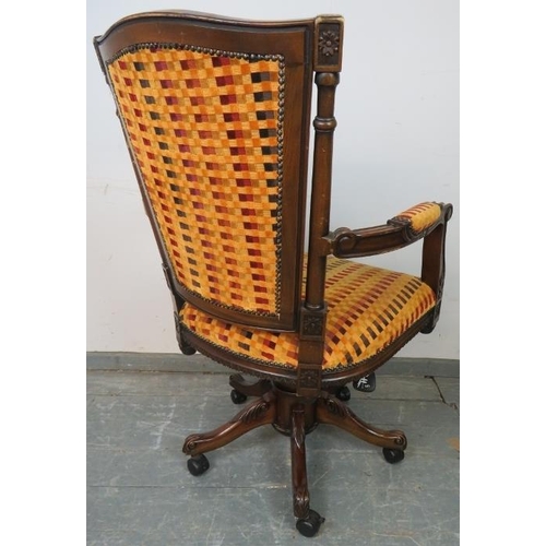 737 - An Edwardian style mahogany captain’s swivel and height adjust desk chair with carved frame and scro... 