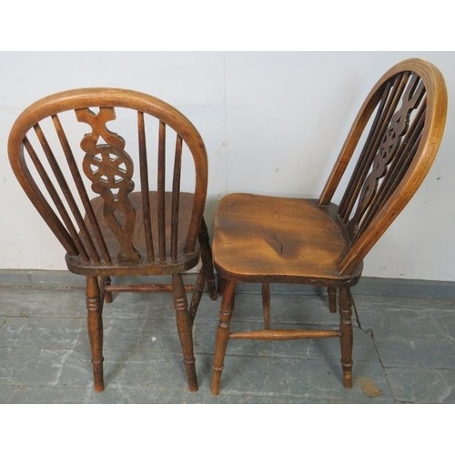 738 - Five elm wheelback dining chairs, on turned supports with an ‘H’ stretcher. 
H89cm W41cm D47cm (appr... 