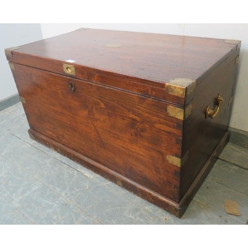 742 - An antique stained pine flat-top trunk/blanket box with brass mounts and campaign style handle, the ... 