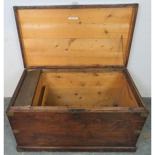 742 - An antique stained pine flat-top trunk/blanket box with brass mounts and campaign style handle, the ... 