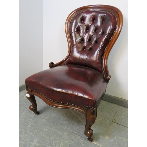 746 - A Victorian mahogany spoonback chair, upholstered in burgundy leather with brass studs, on scrolled ... 