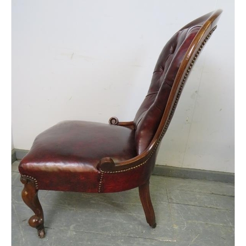 746 - A Victorian mahogany spoonback chair, upholstered in burgundy leather with brass studs, on scrolled ... 