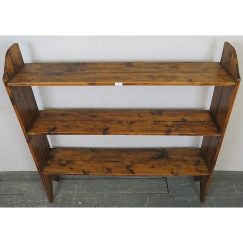 750 - An antique pine open bookcase of three shelves, on stile supports. 
H122cm W122cm D25cm (approx).
Co... 