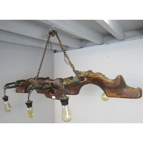 752 - A novelty pendant ceiling light, formed of an antique elm and cast-iron yoke with six light fittings... 