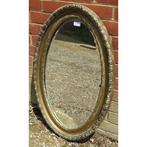 757 - A 19th century oval bevelled wall mirror, in a moulded gilt gesso surround. 
H82cm W54cm D4cm (appro... 