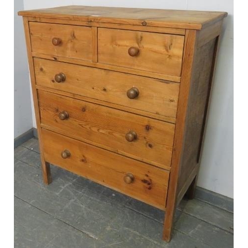 763 - An antique pine shaker style chest of two short over three long graduated drawers with turned wooden... 