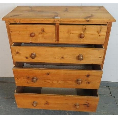 763 - An antique pine shaker style chest of two short over three long graduated drawers with turned wooden... 