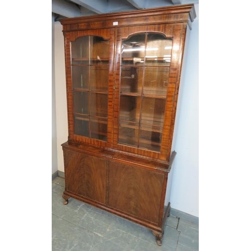 766 - An antique flame mahogany tall glazed bookcase, the tracery doors opening onto three height adjustab... 