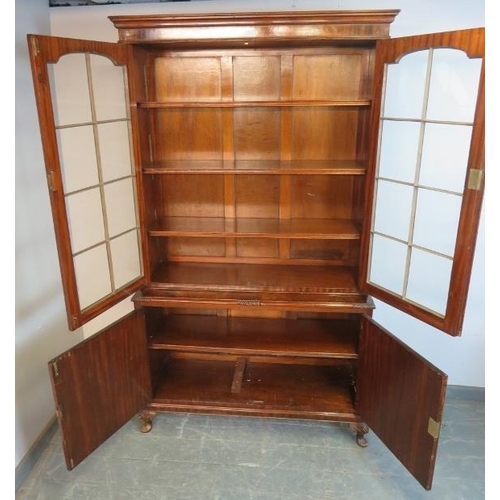 766 - An antique flame mahogany tall glazed bookcase, the tracery doors opening onto three height adjustab... 