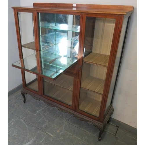 773 - An Edwardian walnut side cabinet strung with satinwood, the fall front central section housing a dri... 