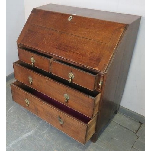 779 - An 18th century oak bureau, the fall front opening onto a fitted interior, above two short and two l... 