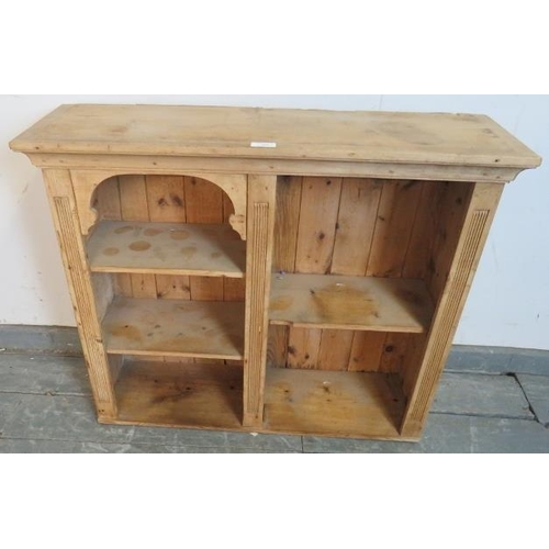 783 - An antique stripped pine Continental wall shelf, of four open shelves with reeded detail. 
H68cm W92... 