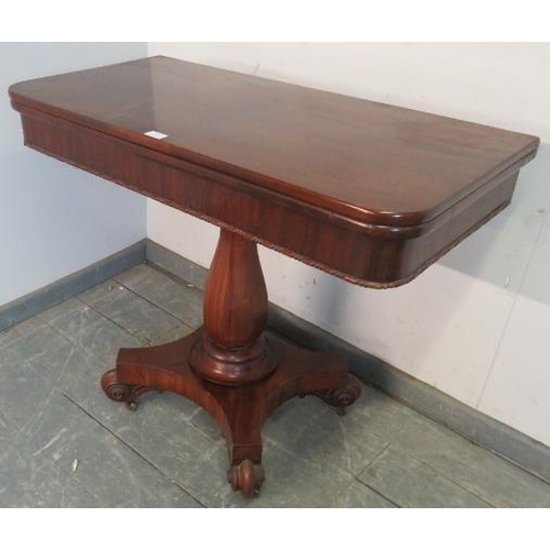 785 - A Victorian mahogany turnover tea table, on an octagonal baluster pedestal, above a quatreform base ... 