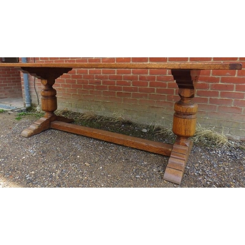 788 - A light oak refectory dining table in the 17th century taste, on cup and cover end supports with spl... 