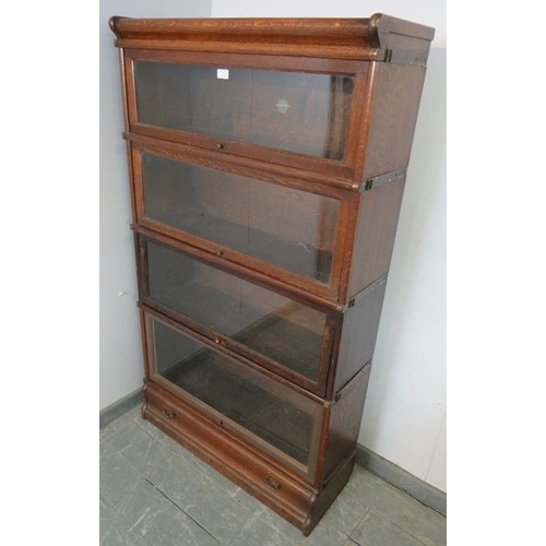 792 - A vintage oak Globe-Wernicke glazed bookcase, of four stacking sections, above one long drawer, on a... 