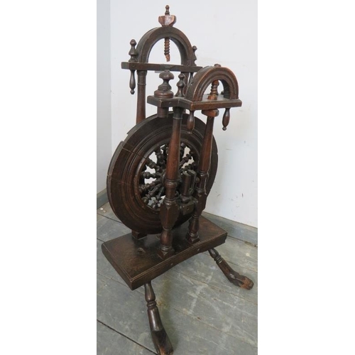 801 - A 19th century oak spinning wheel, on splayed supports. 
H85cm W40cm D42cm (approx).
Condition repor... 